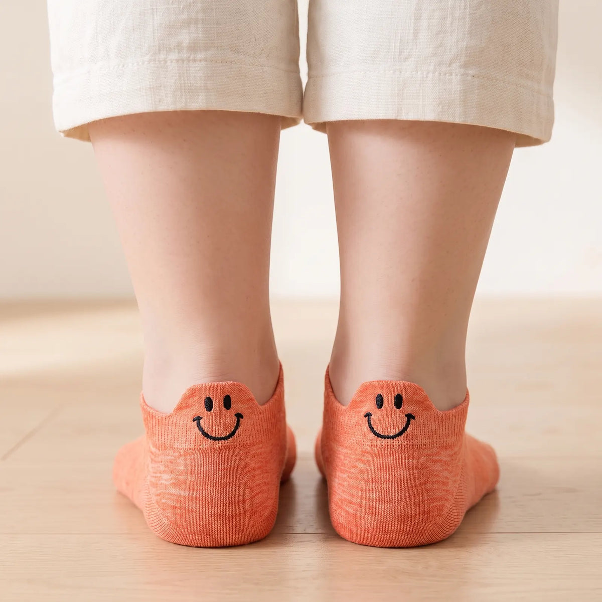 Orange smile ankle socks worn